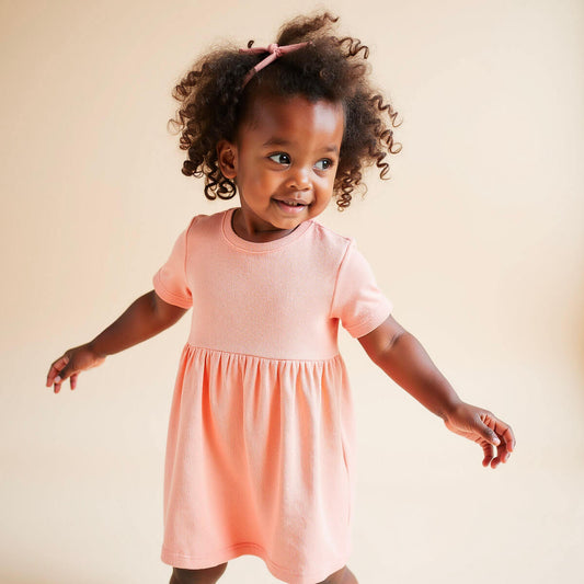 little girl wearing pink organic cotton dress