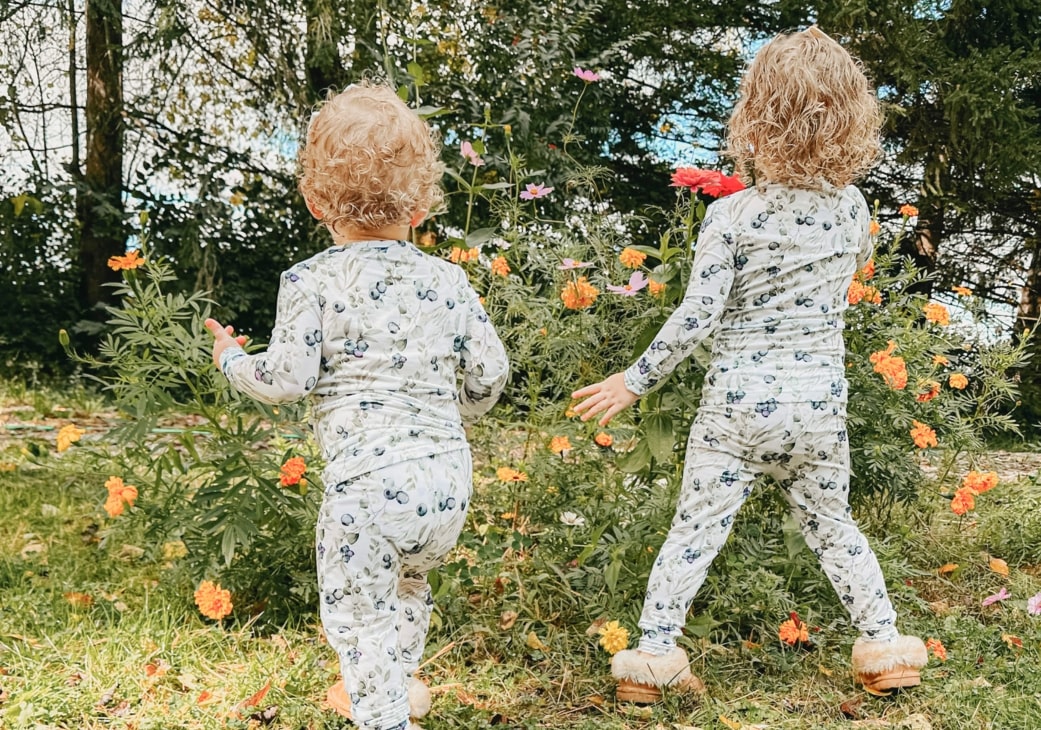 little girls outdoors wearing blueberry pajamas from cuddle sprouts