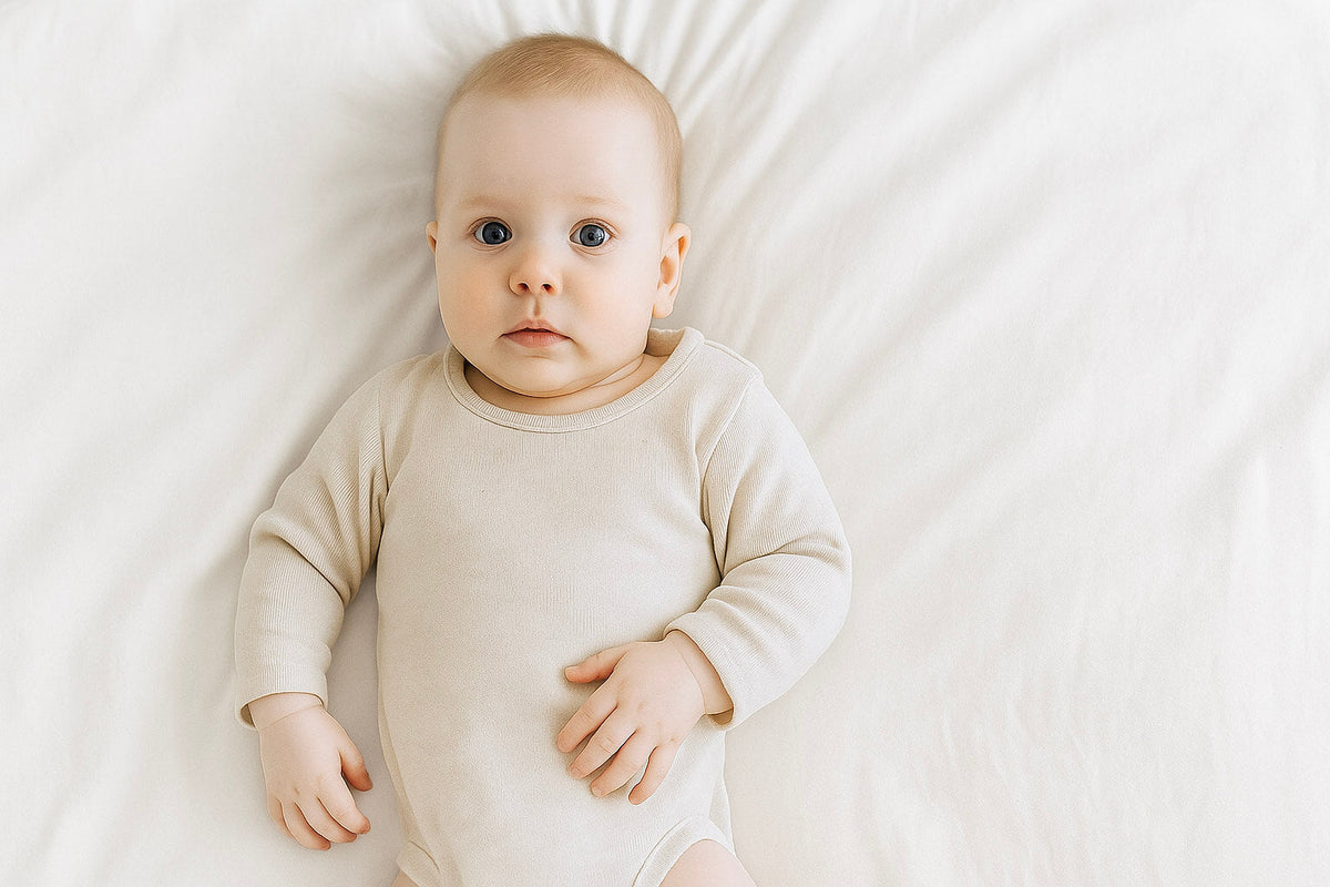 baby boy wearing cream bodysuit