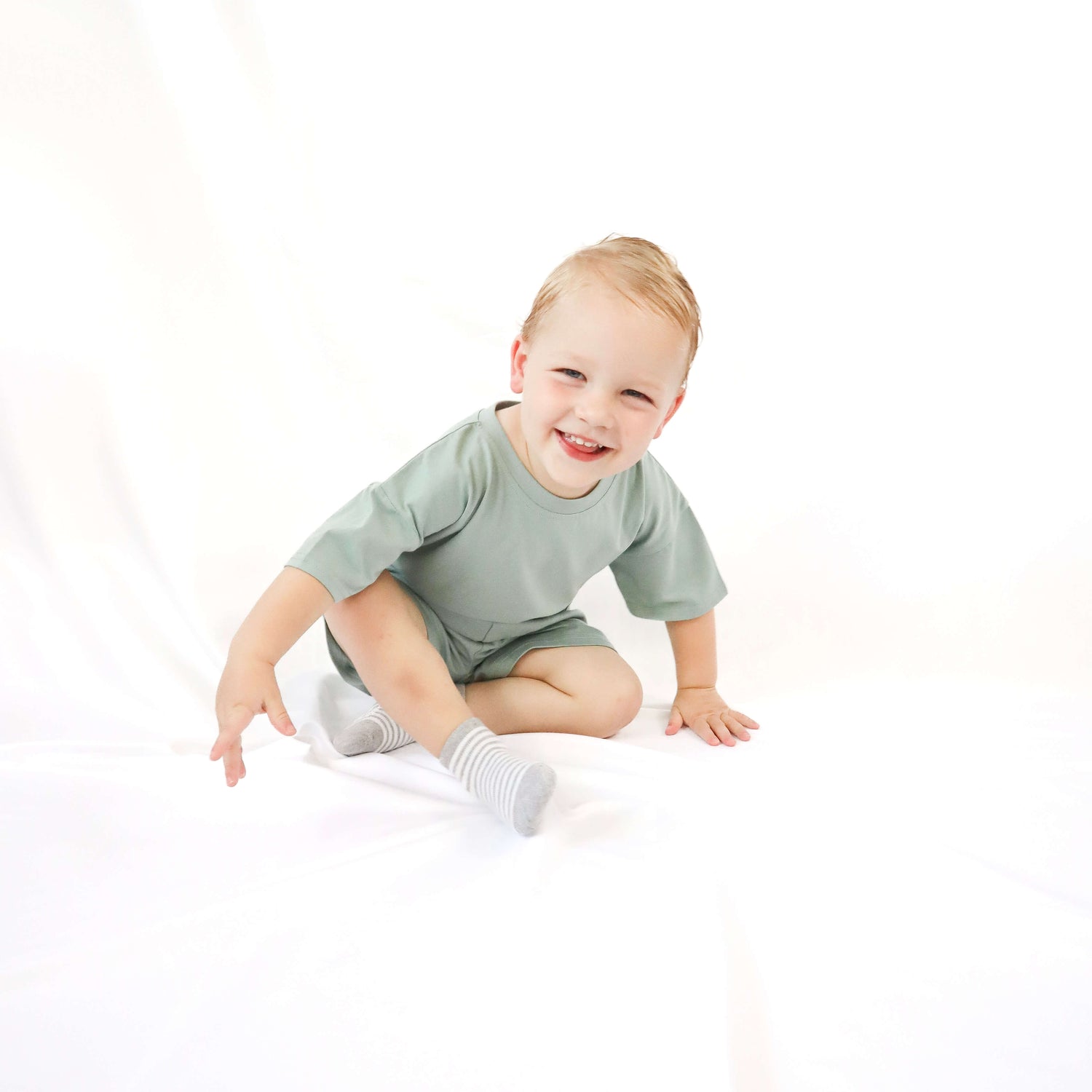 toddler sitting while smiling