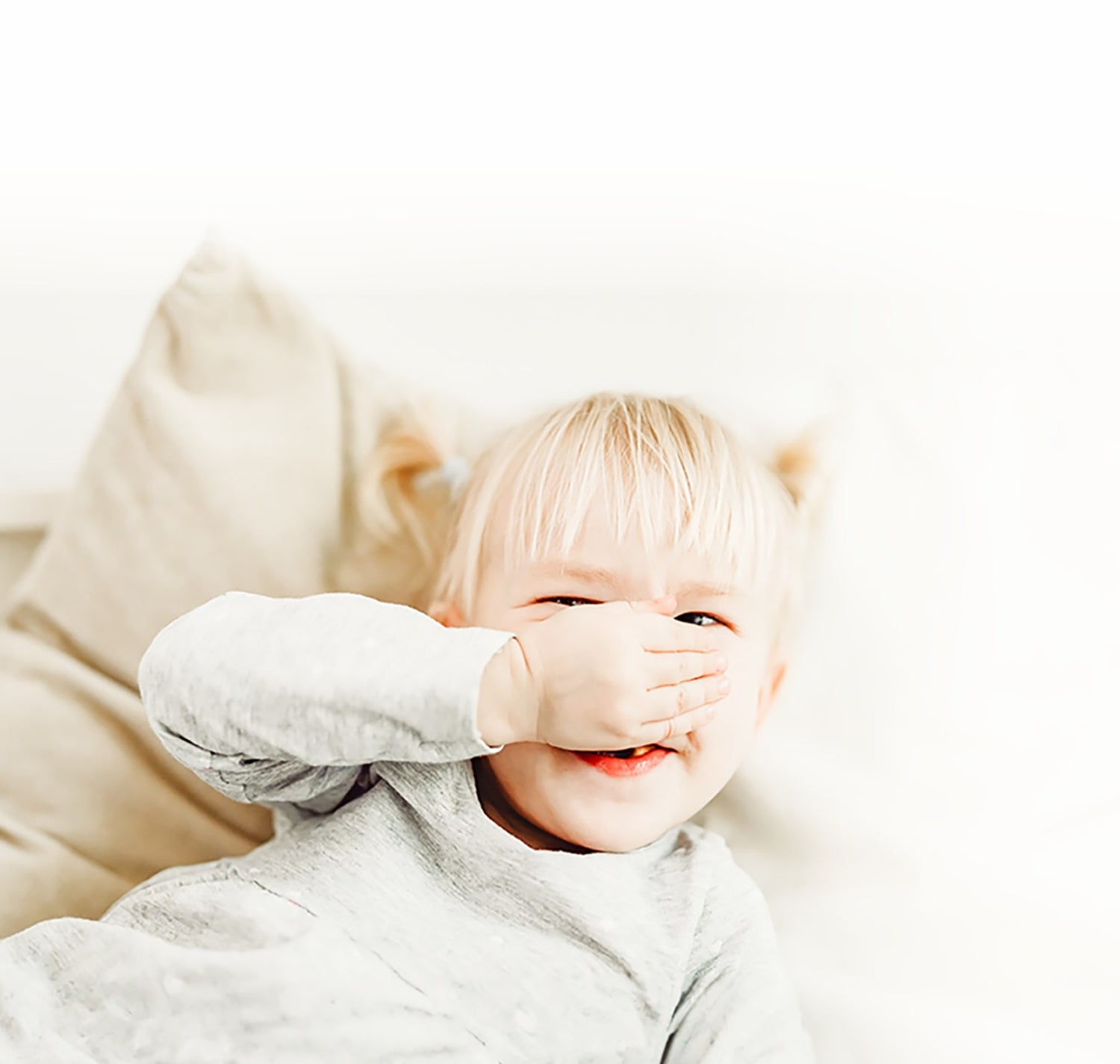 baby girl smiling while wearing toddler pajamas