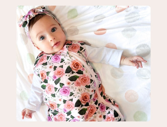baby girl wearing cuddle sprouts sleep sack in precious petals 
