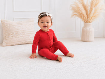 baby girl wearing red footie