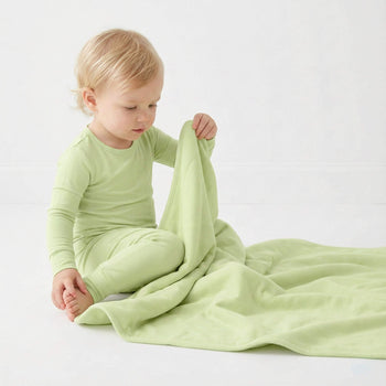 toddler wearing green pajama 