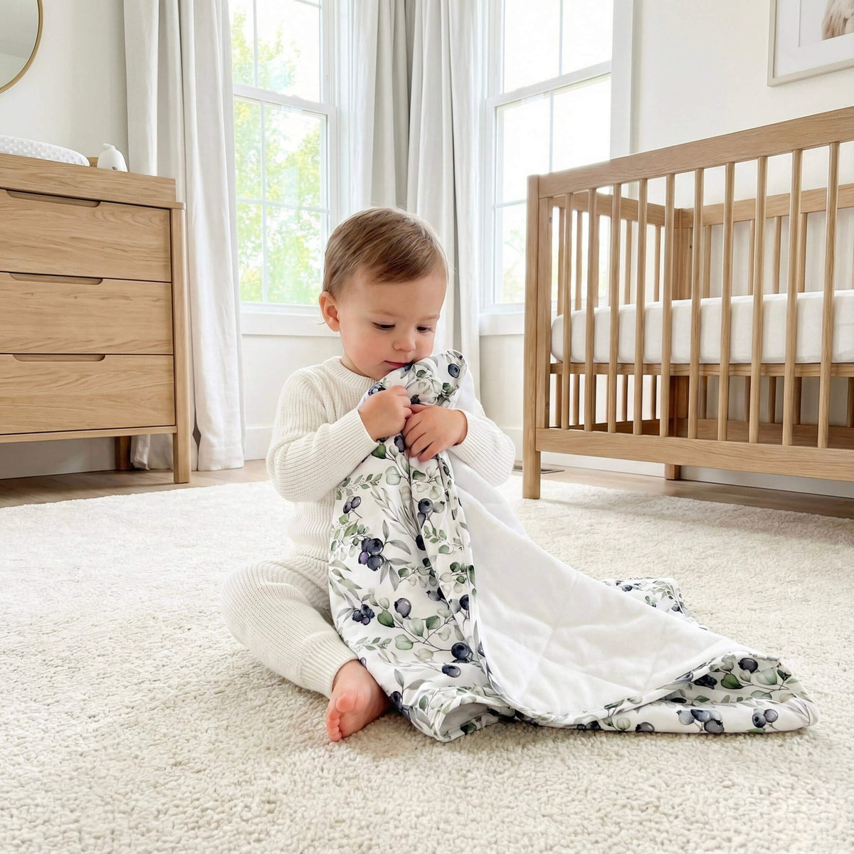 baby holding blueberry pajama