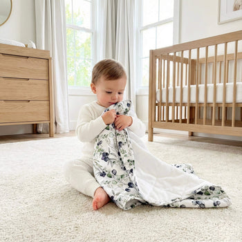 baby holding blueberry pajama