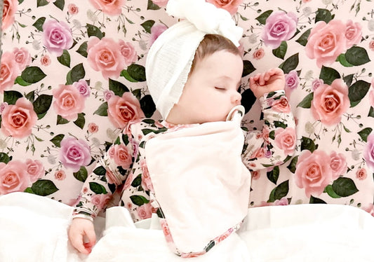 baby girl sleeping while wearing cuddle sprouts tencel clothing 