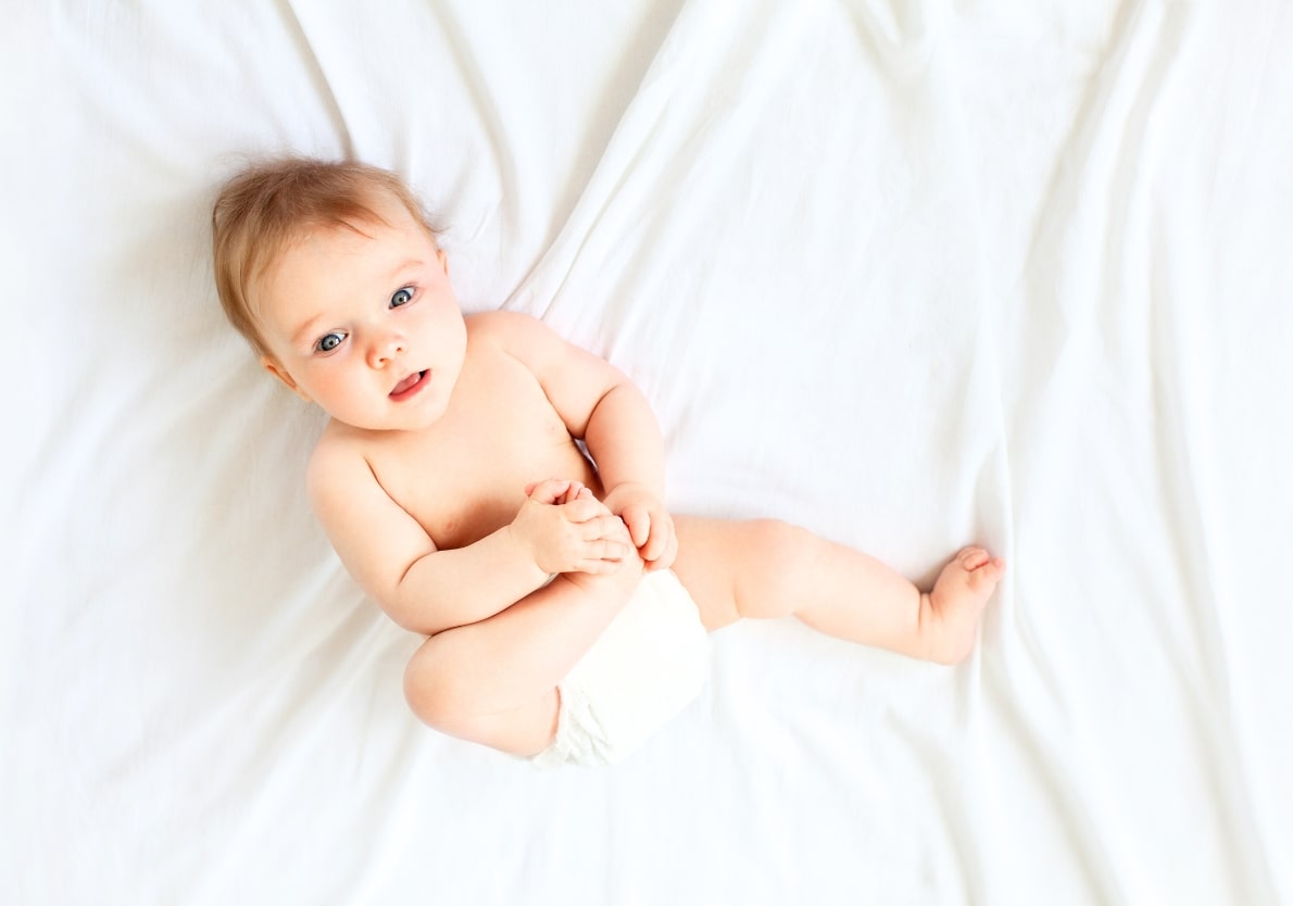 Baby holding his leg 