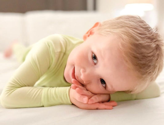 baby boy wearing green pajamas from Cuddle Sprouts 
