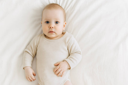 baby boy wearing cream bodysuit