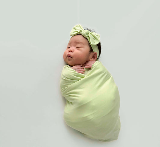 swaddle baby girl wearing green swaddle set