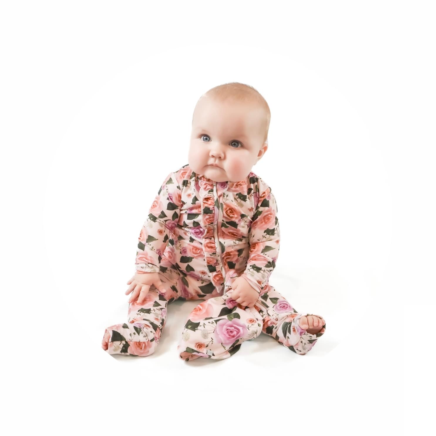 Baby girl wearing toddler clothes in floral pattern 