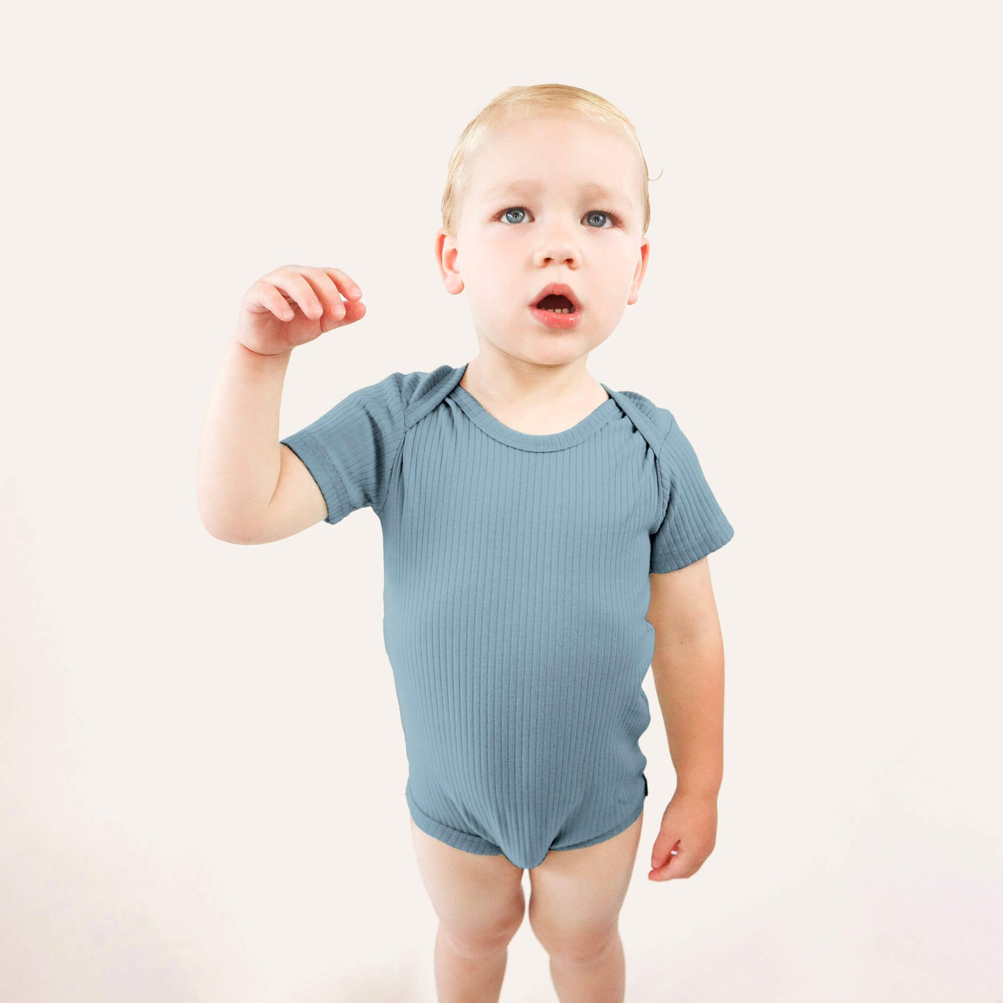 baby wearing blue bodysuit 