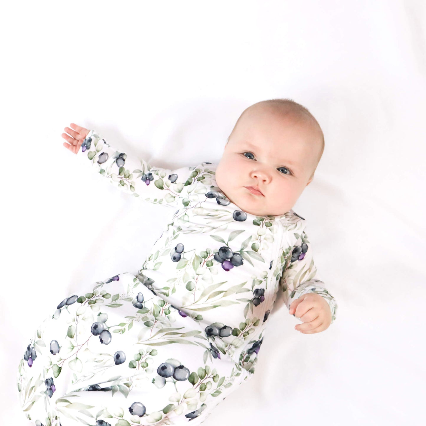 baby girl wearing blueberry sleep sack