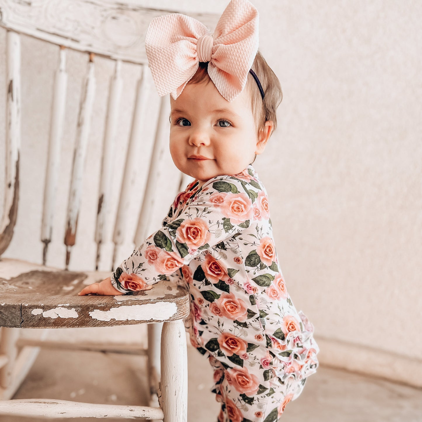 toddler baby girl wearing baby sleepers pajamas in floral print