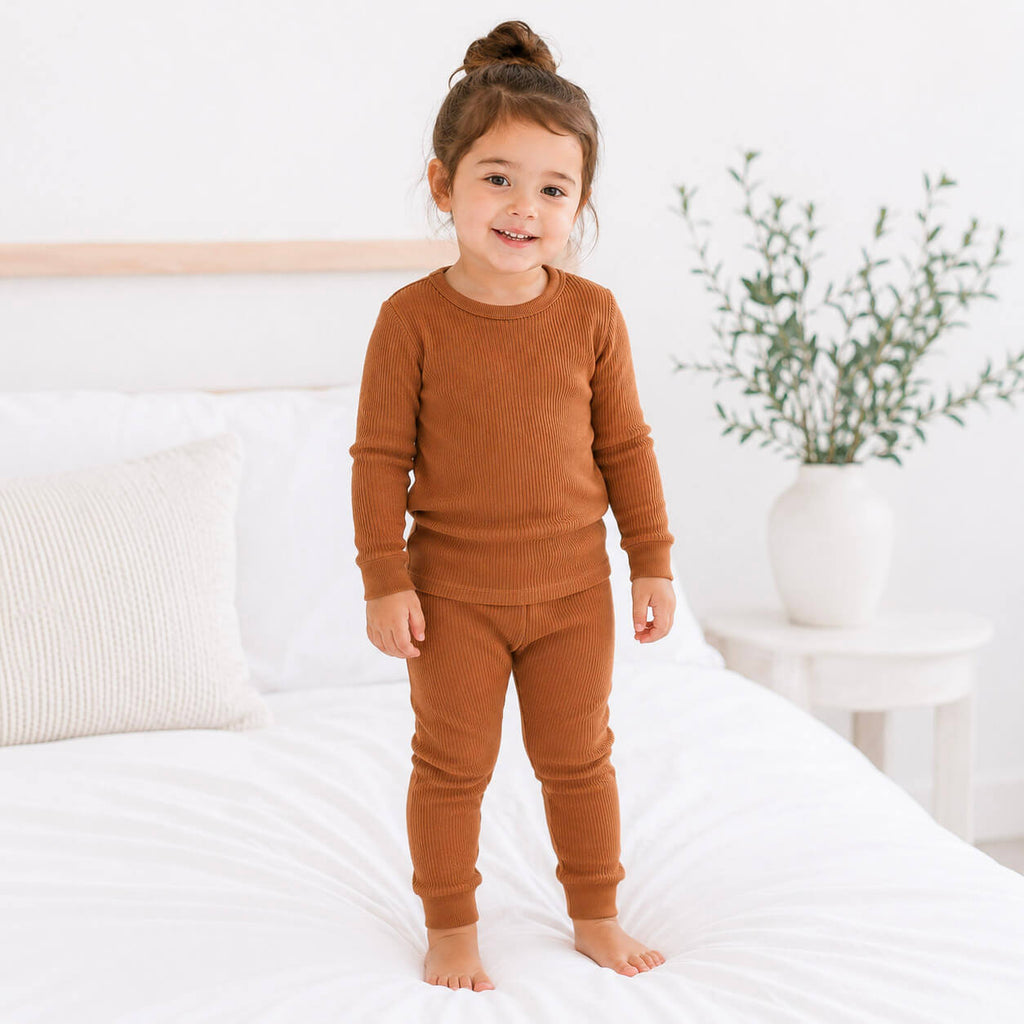 toddler girl wearing brown ribbed pajama set