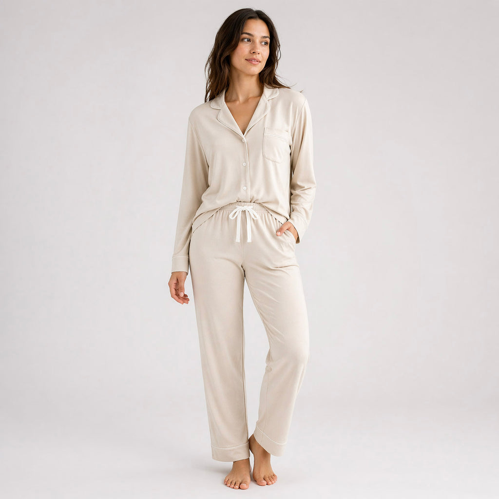 Woman wearing a beige pajama set on a white background