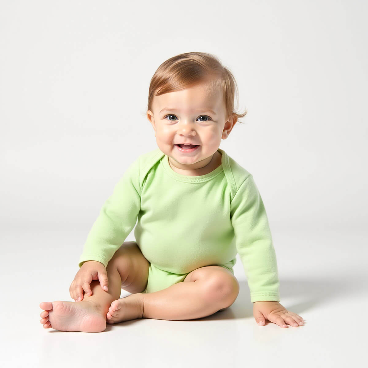 baby boy wearing light green long sleeve bodysuit 