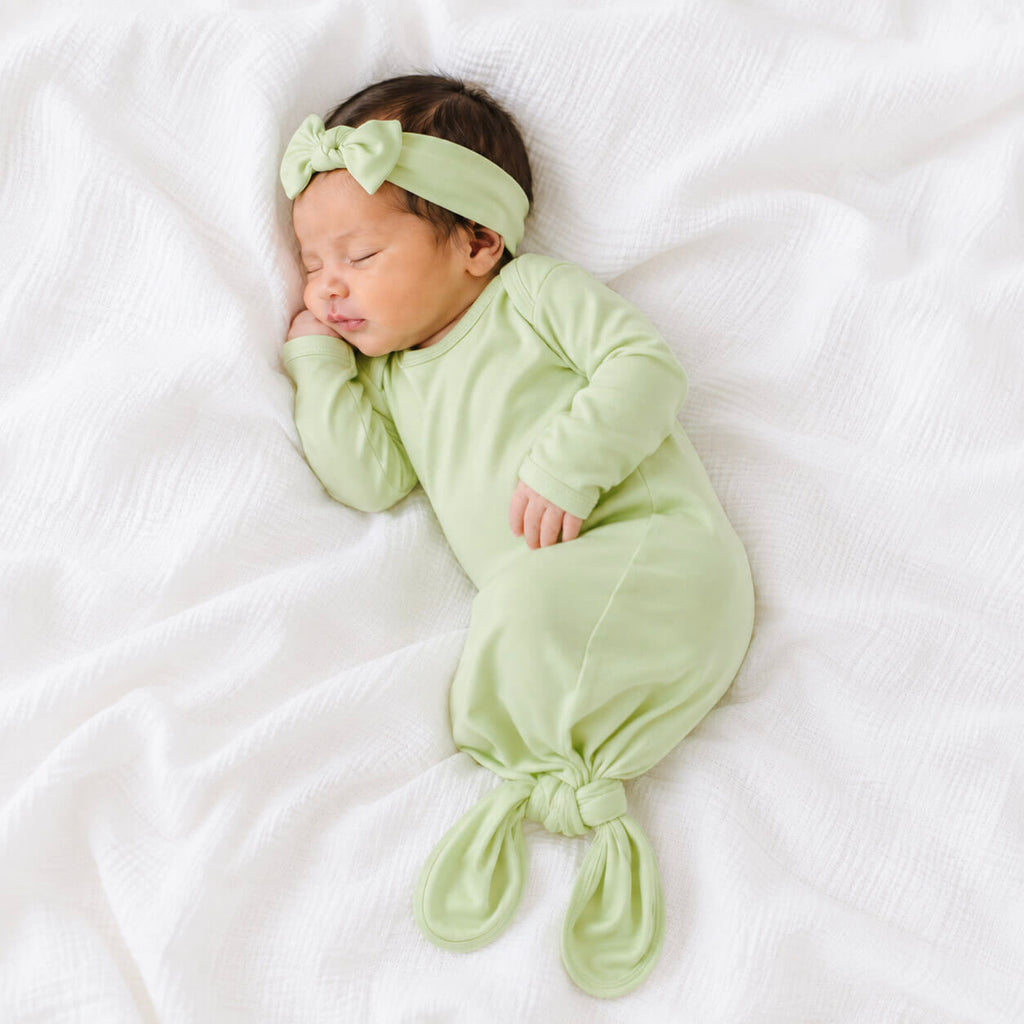 newborn baby wearing green gown