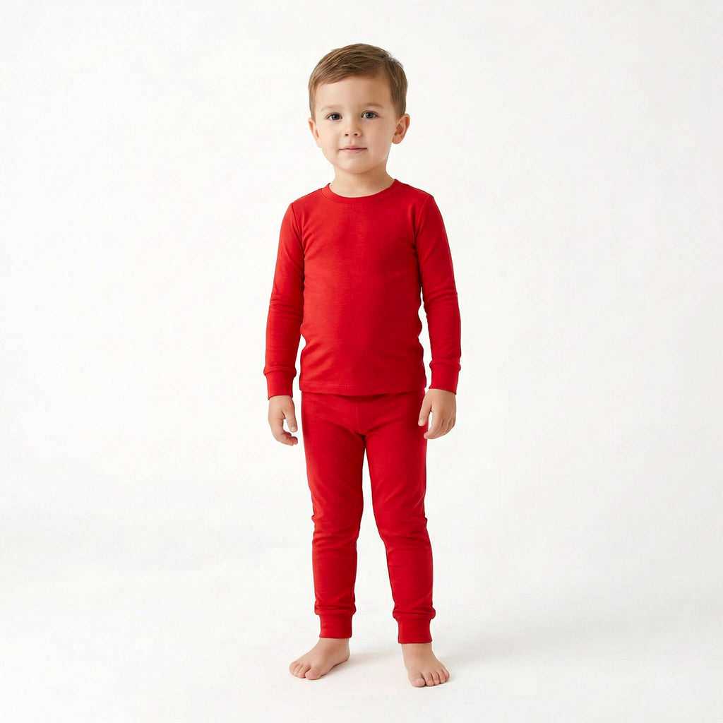 Child wearing red pajamas on a white background