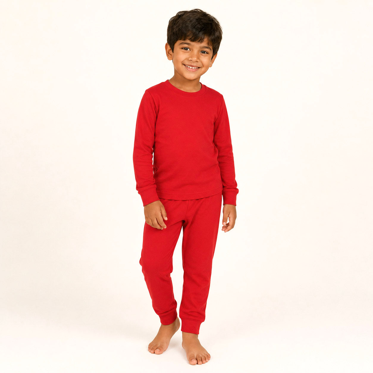 Child wearing red pajamas on a white background