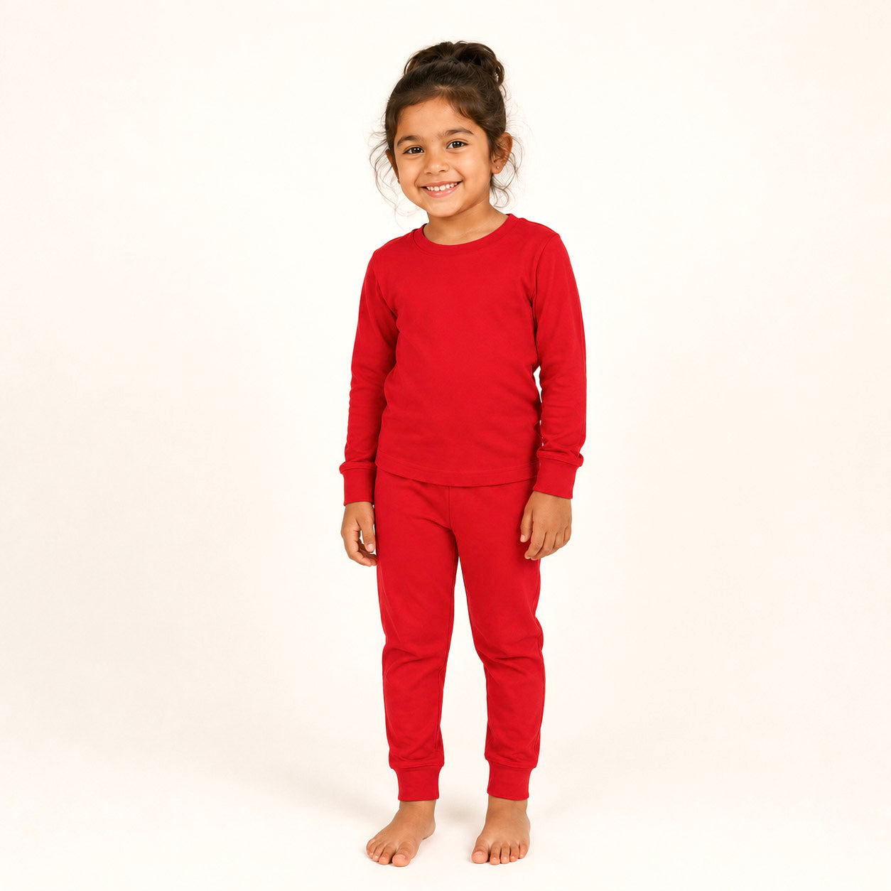 Child wearing red pajamas on a white background