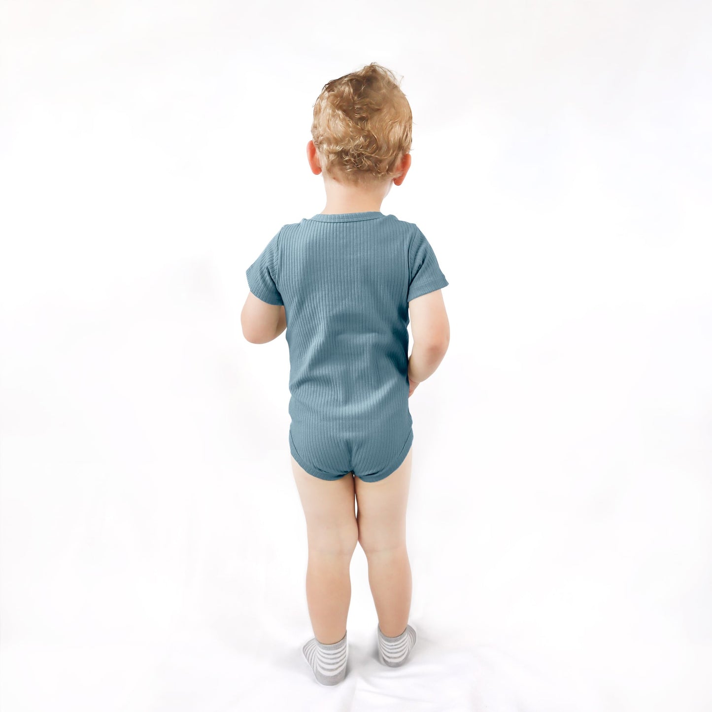 toddler wearing blue ribbed bodysuit