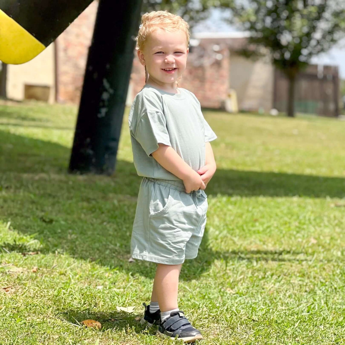 little boy outdoors wearing summer set in Sage Green color