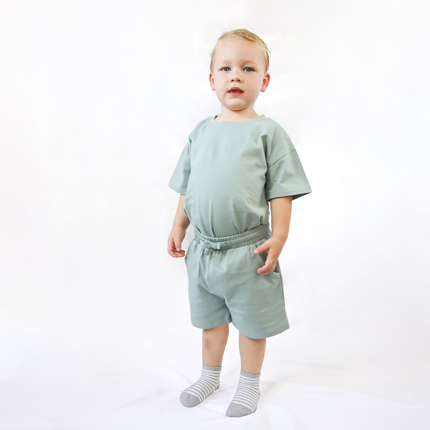 Boy wearing summer set in Sage Green color