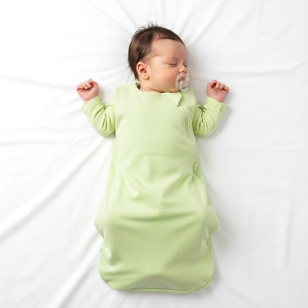 baby wearing green sleep sack
