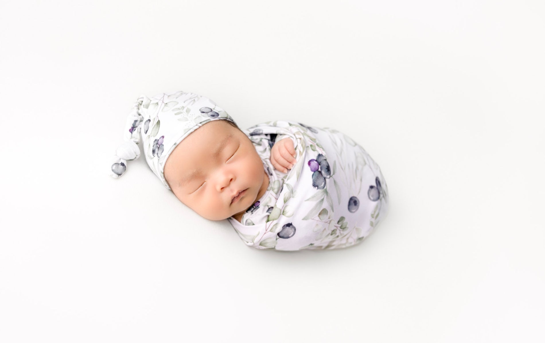 newborn swaddle wearing blueberries print 