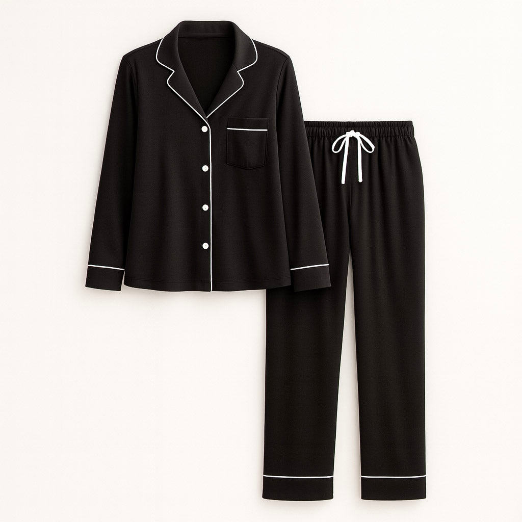 Black pajama set with white piping on a white background